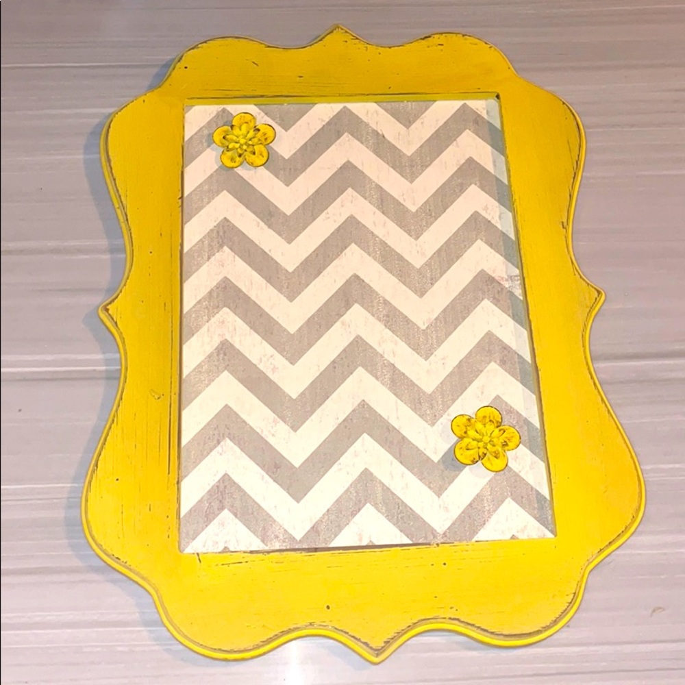 Chevron magnetic board with two flower magnets.